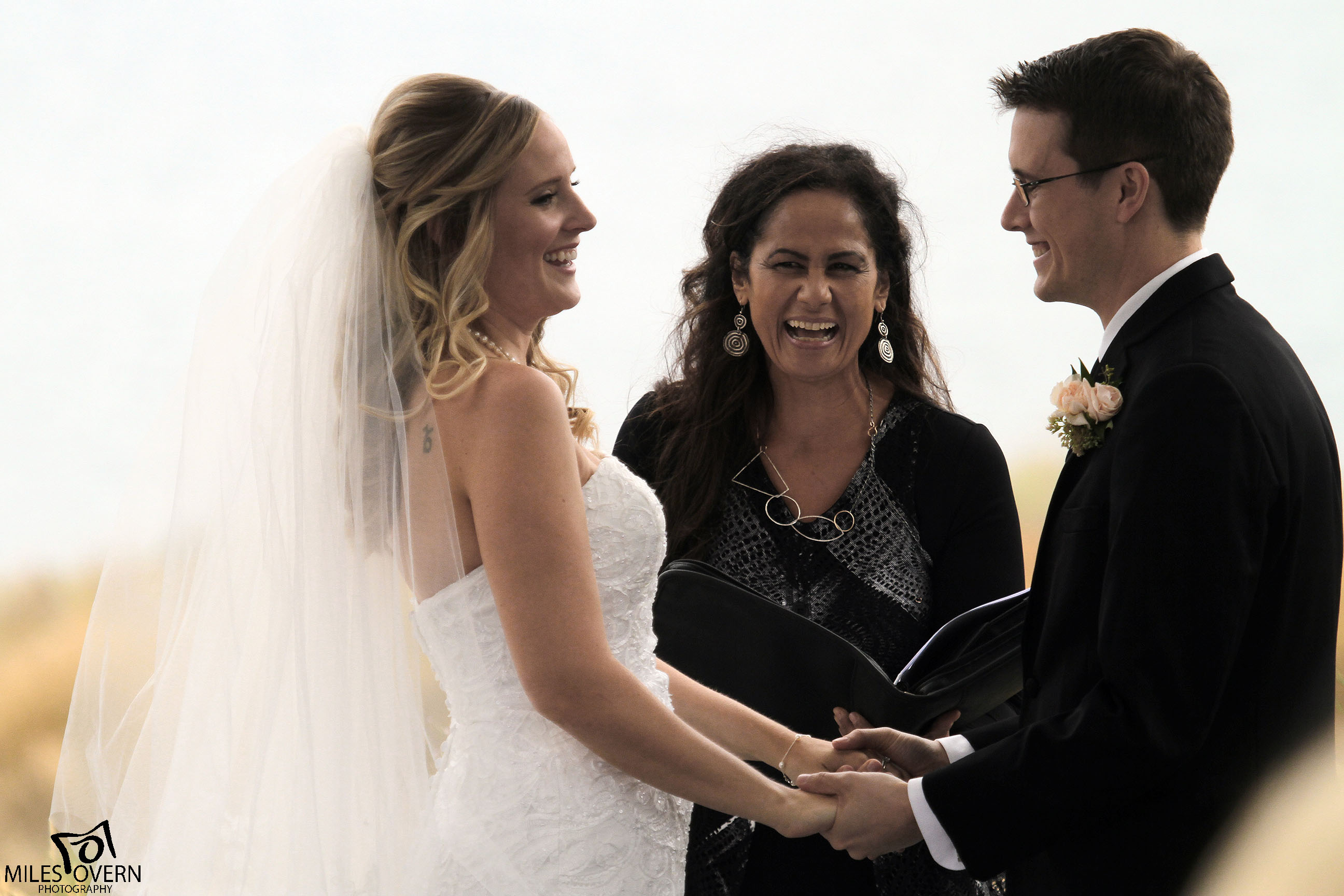 Wedding Photo of Couple and Officiant at Sanctuary Gardens